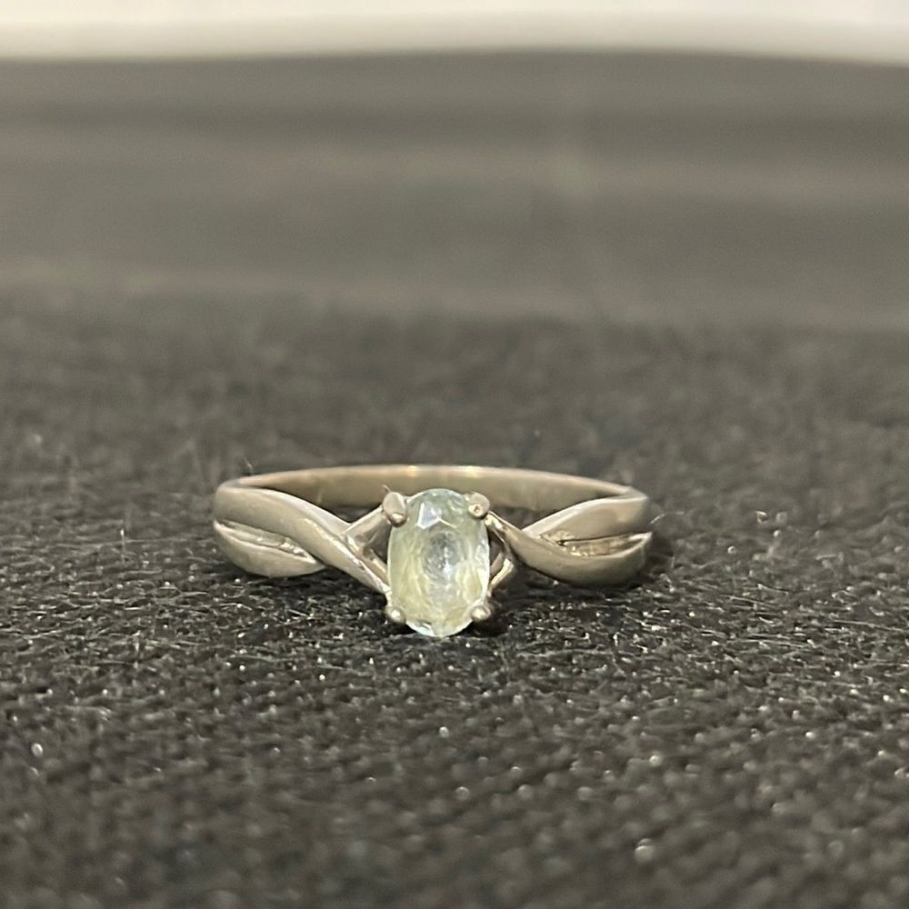 Thin ring with a white gem